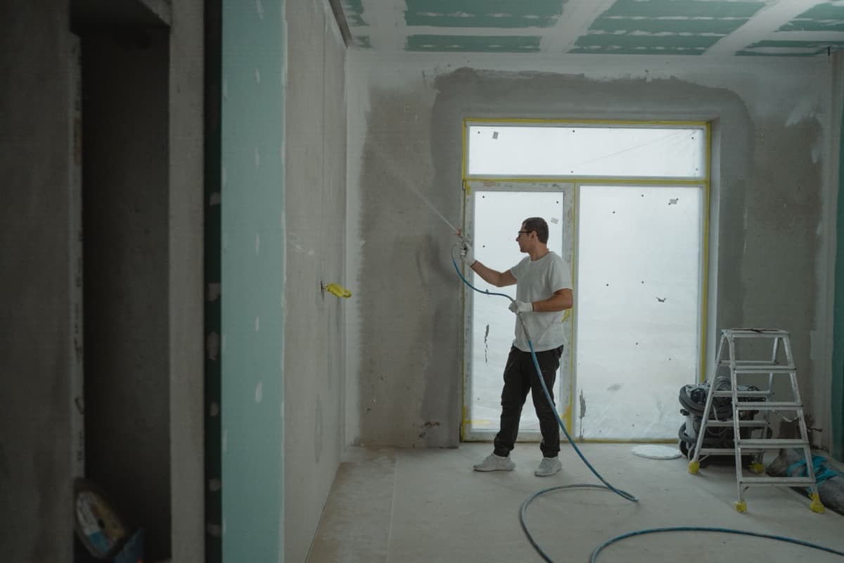 Skilled tradesperson spray finishing an interior renovation