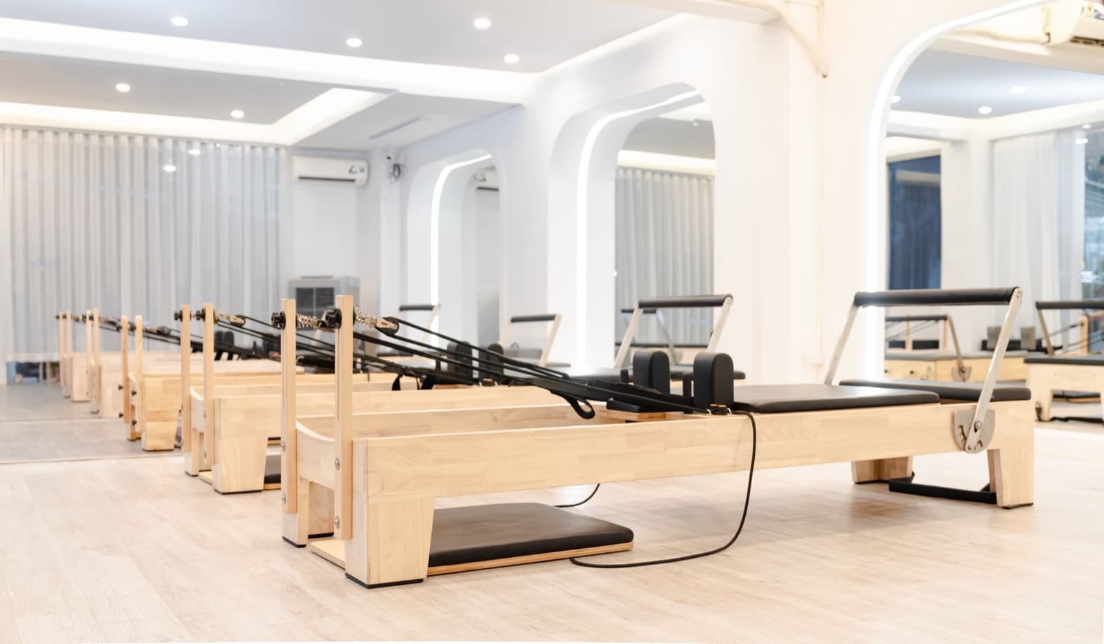 Modern Pilates reformer studio with professional equipment