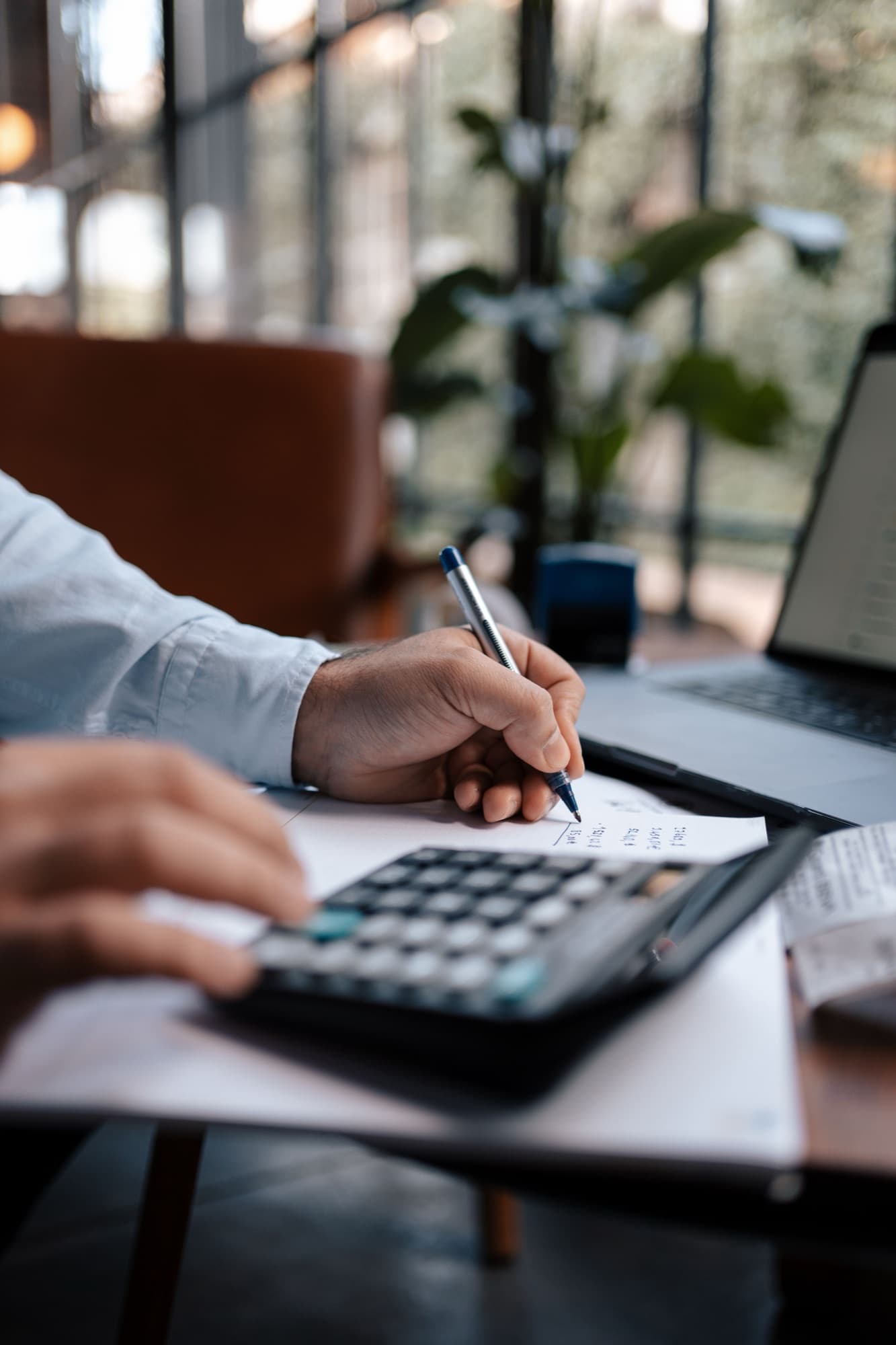 Business owner reviewing finances with a calculator